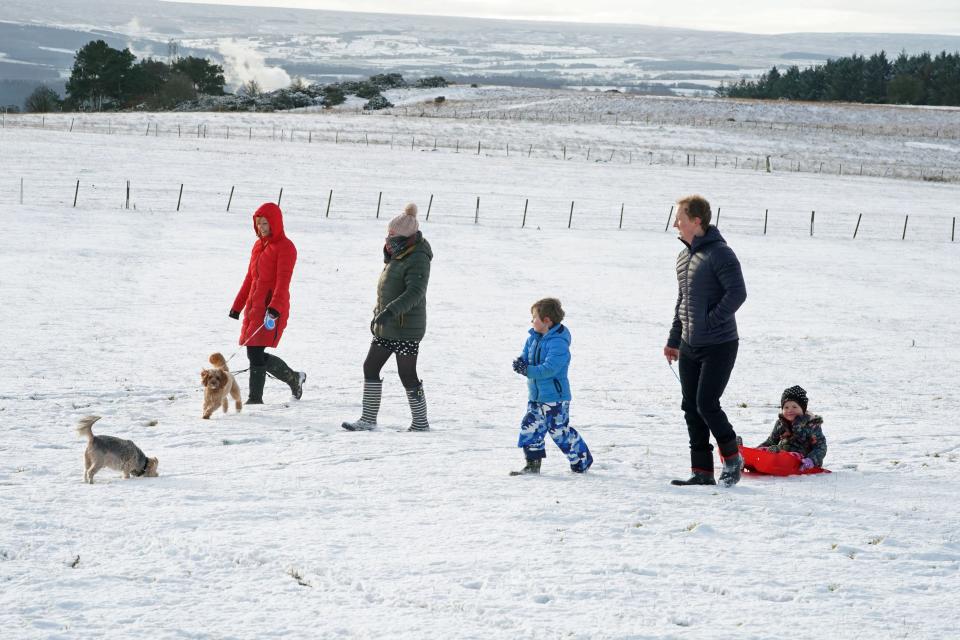 A family take advantage of the Christmas Day snow with a trip out sledging on the hills near Hexham, NorthumberlandPA