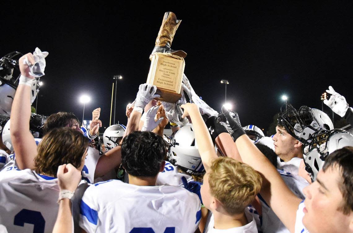 Centenial’s football team celebrates after receiving the trophy for defeating crosstown rivals Burleson 42-13 in the Boot Bowl football game Friday, August 26, 2022 at Elk Stadium in Burleson, Texas. Special/Bob Haynes