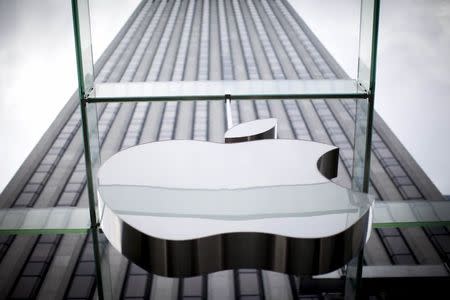 An Apple logo hangs above the entrance to the Apple store on 5th Avenue in New York City, in this file photo taken July 21, 2015. The U.S. Supreme Court on Monday declined to hear Apple Inc's challenge to an appellate court decision that it conspired with five publishers to increase e-book prices, meaning it will have to pay $450 million as part of a settlement. REUTERS/Mike Segar/Files