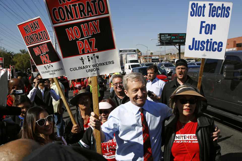 FILE - In this Feb. 19, 2020, file photo, Democratic presidential candidate, businessman Tom Steyer walks on a picket line with members of the Culinary Workers Union Local 226 outside the Palms Casino in Las Vegas. The Democratic presidential contest has moved to immigrant-heavy Nevada, but the issues of immigration are seldom getting a thorough airing on the campaign trail. Candidates usually throw in a quick condemnation of President Donald Trump's hard-line policies but have shied away from outlining their own immigration positions. Immigration groups say that points to a potential vulnerability for whoever is the Democratic nominee later this year. (AP Photo/Patrick Semansky, File)