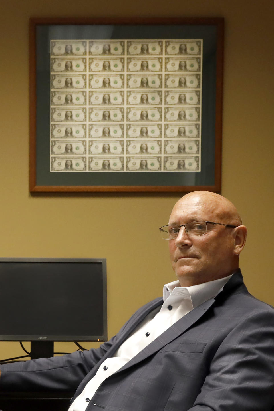 Brad Clark, President of Tompkins State Bank, poses for a portrait, Tuesday, June 15, 2021, in Galesburg, Ill. Clark says he has struggled to fill teller positions, a common theme among the local businesses his north-side branch serves and blames extended unemployment benefits that were part of the federal Covid response for encouraging workers to stay idle, and fears they are nudging inflation upward. (AP Photo/Shafkat Anowar)