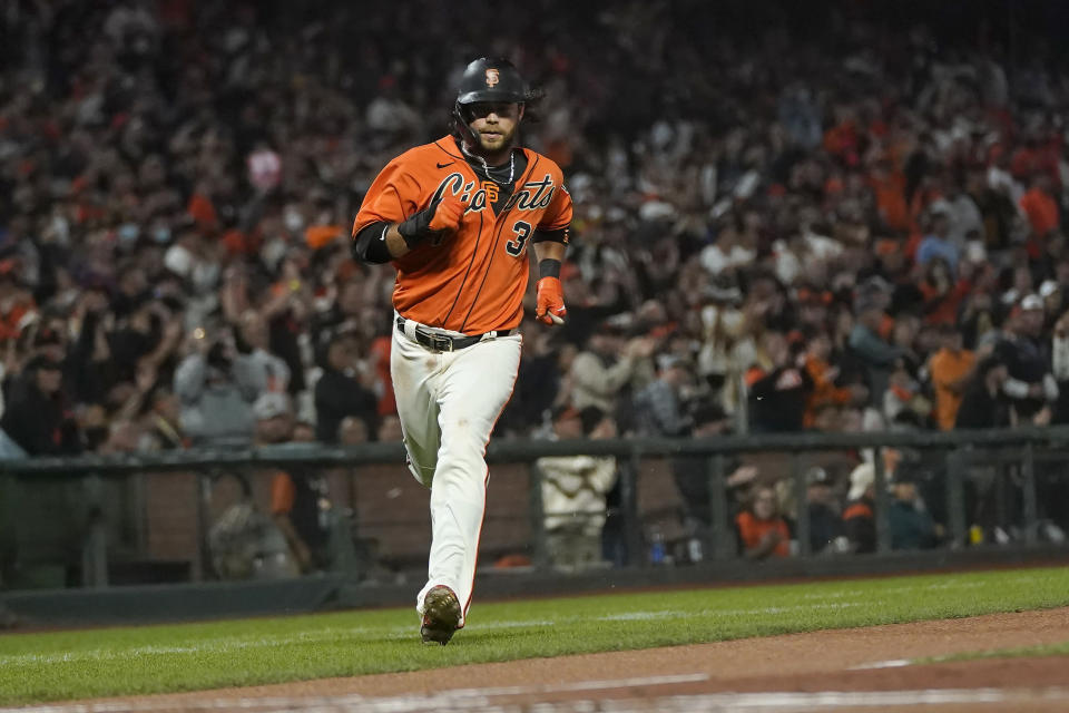 San Francisco Giants' Brandon Crawford runs home to score against the San Diego Padres during the first inning of a baseball game in San Francisco, Friday, Oct. 1, 2021. (AP Photo/Jeff Chiu)