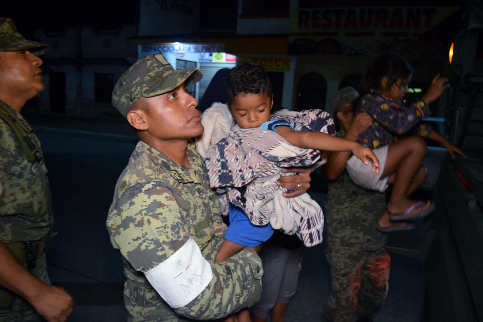 <p>Soldiers help children to get on a truck as residents are being evacuated from their coastal town after an earthquake struck off the southern coast, in Puerto Madero, Mexico, Sept. 8, 2017. (Photo: Jose Torres/Reuters) </p>