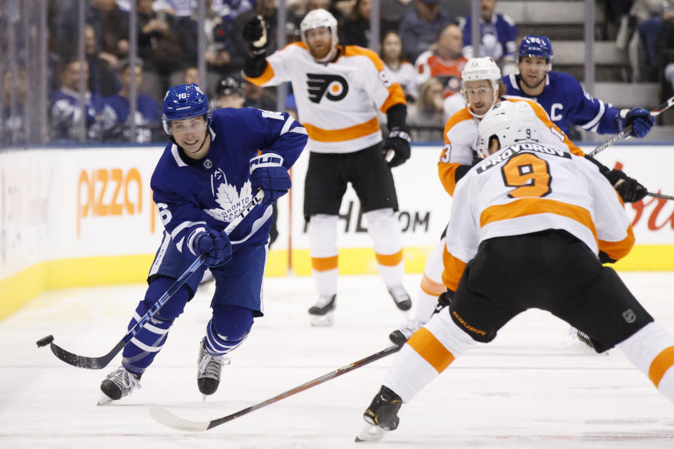 FILE - In this Nov. 9, 2019, file photo, Toronto Maple Leafs center Mitch Marner (16) passes the puck upice during the first period of an NHL hockey game against the Philadelphia Flyers in Toronto. The rear-view mirror is something Toronto stars Marner and Auston Matthews are doing their best to ignore as the NHL season approaches. (Cole Burston/The Canadian Press via AP, File)
