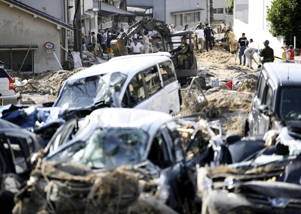 <p>Cars are trapped in mud as residents clean up after days of heavy rain hit southwestern Japan, in Hiroshima city, southwestern Japan, Tuesday, July 10, 2018. (Photo: Ryosuke Ozawa/Kyodo News via AP) </p>