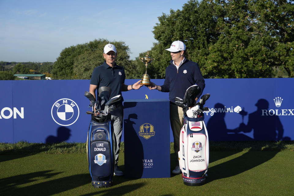 European Captain Luke Donald, left, and United States Captain Zach Johnson pose with the Ryder Cup trophy before an exhibition match on the occasion of The Year to Go event at the Marco Simone course that will host the 2023 Ryder Cup, in Guidonia Montecelio, near Rome, Italy, Monday, Oct. 3, 2022. (AP Photo/Alessandra Tarantino)