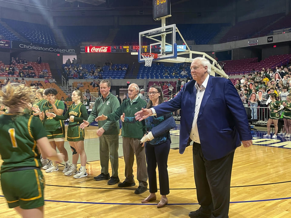 West Virginia Gov. Jim Justice, right, greets members of the Greenbrier East High School girls basketball team at the state tournament Tuesday, March 5, 2024, in Charleston, W.Va. Justice is the team's coach. (AP Photo/John Raby)