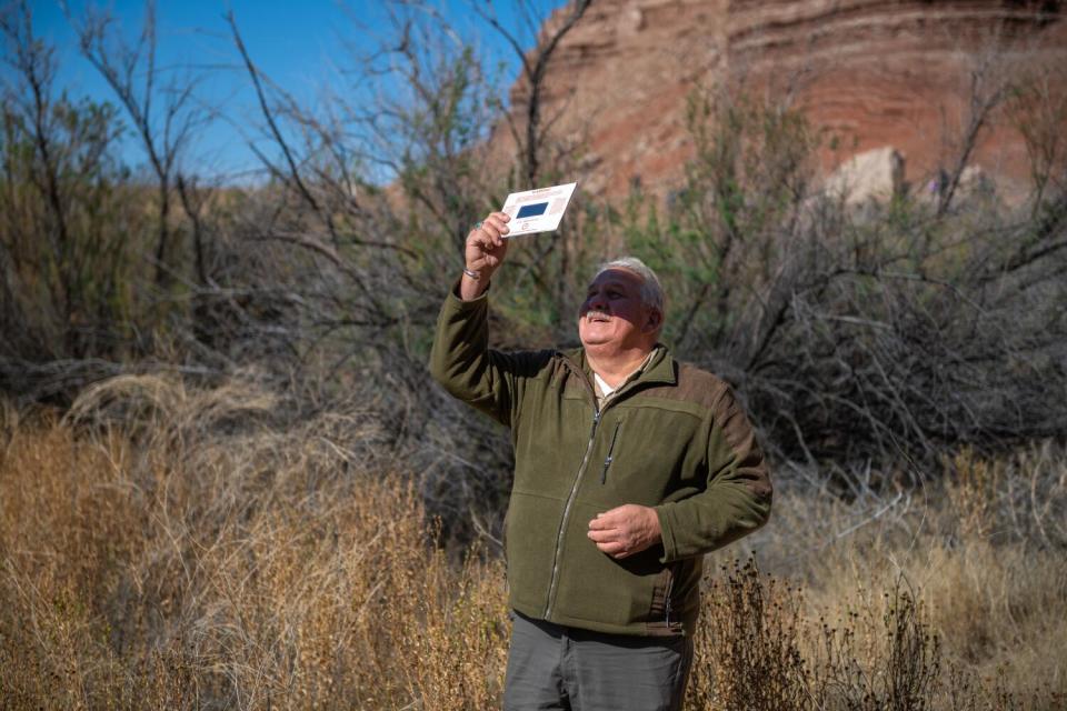 A man watches a solar eclipse.