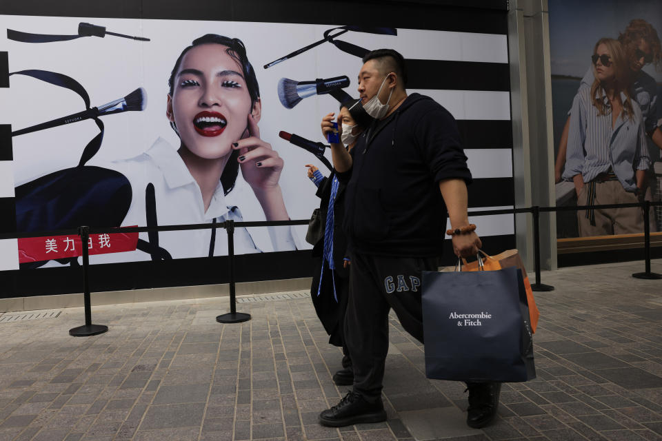 Shoppers visit a retail district in Beijing on Thursday, April 15, 2021. China’s economic growth surged to 18.3% over a year earlier in the first quarter of this year as factory and consumer activity recovered from the coronavirus pandemic. (AP Photo/Ng Han Guan)