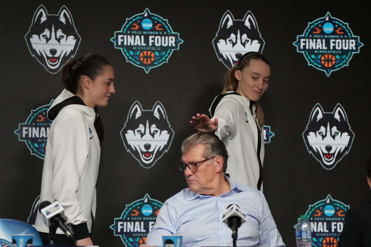 Paige Bueckers jokes with UConn head coach Geno Auriemma (middle) while walking off stage after a news conference after the Final Four semifinals on April 1, 2022. (Kirby Lee/USA TODAY Sports)
