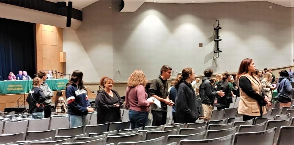 Showing their disdain for proposed budget cuts, audience members turned their back Thursday night on the Sussex County Technical School board.