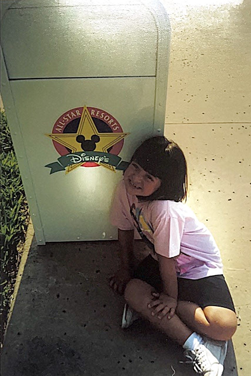 megan posing with a trash can at disney's all star resorts as a kid 30 years ago