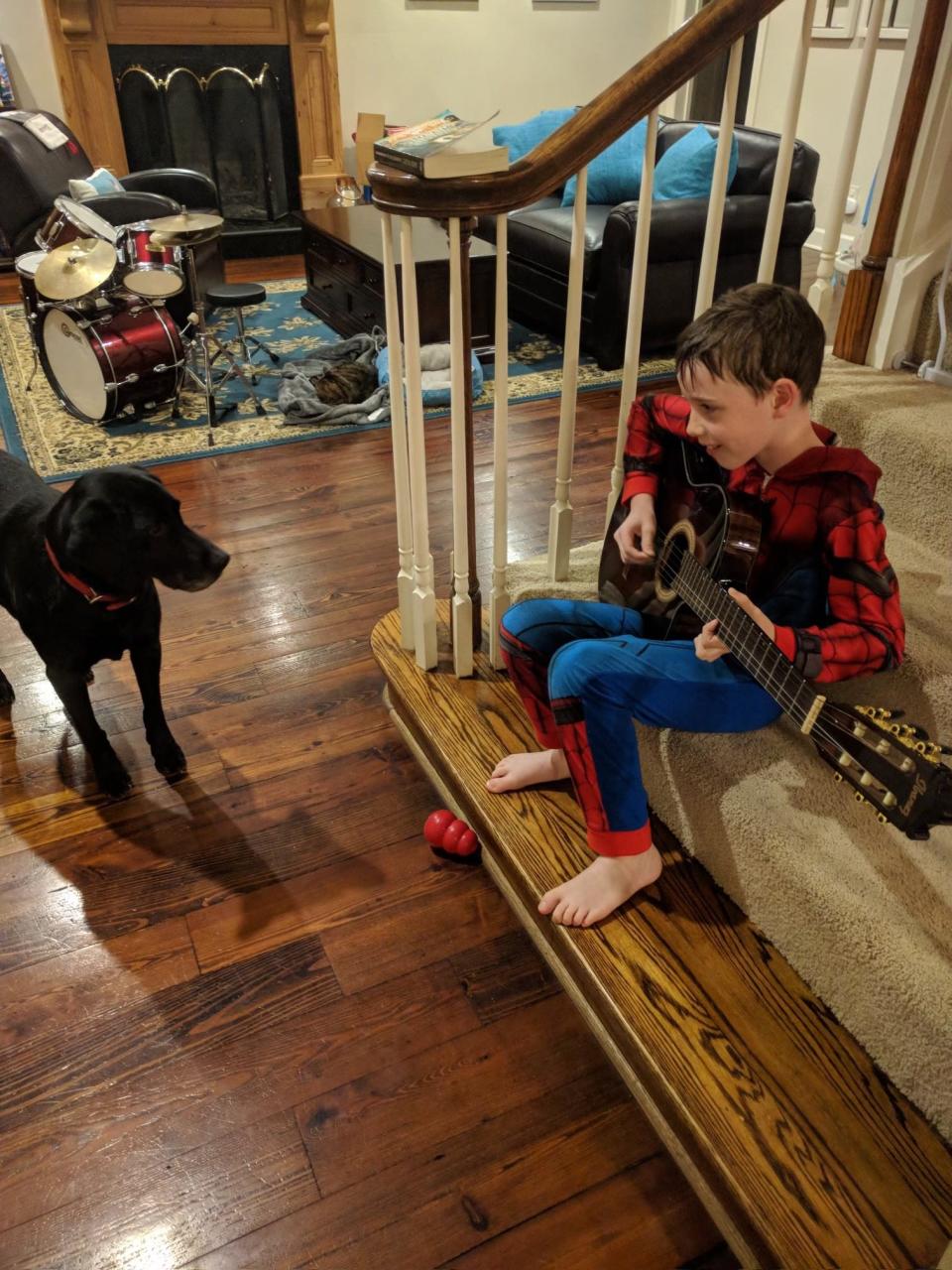 Ian Farley plays the guitar for his dog Jackson.