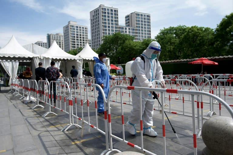 Authorities in China are pursuing a strategy of stamping out the virus entirely, which includes rapid lockdowns and mass testing (AFP/Noel Celis)