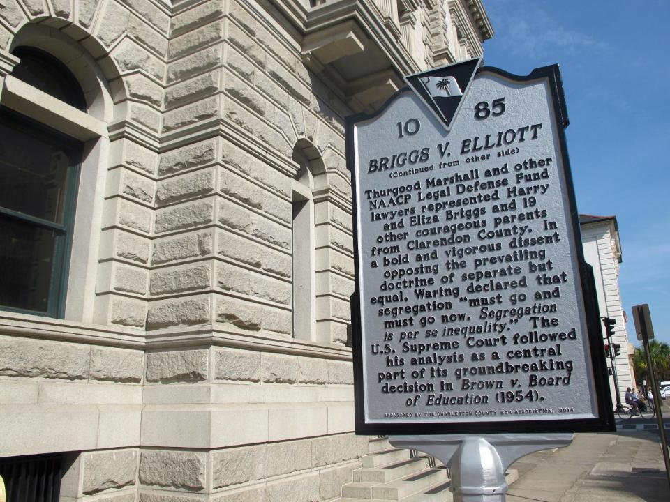 An historical marker describing a key school desegregation case from Clarendon County, S.C., is seen outside the federal courthouse in Charleston, S.C., on April 3, 2014. One of the three judges who heard the case, U.S. District Judge Waites Waring, was the first judge to write an opinion that separate schools are not equal schools since separate but equal became the law of the land in the late 1800s. A statue of Waring is being dedicated outside the courthouse on April 11, 2014. (AP Photo/Bruce Smith)