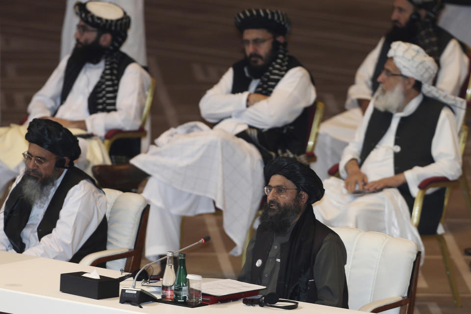 FILE - In this Sept. 12, 2020, file photo, Taliban co-founder Mullah Abdul Ghani Baradar, bottom right, speaks at the opening session of peace talks between the Afghan government and the Taliban in Doha, Qatar. Russia is to host on Thursday, March 18, 2021, the first of three international conferences aimed at jump-starting a stalled Afghanistan peace process ahead of a May 1 deadline for the final withdrawal of U.S. and NATO troops from the country. (AP Photo/Hussein Sayed, File)