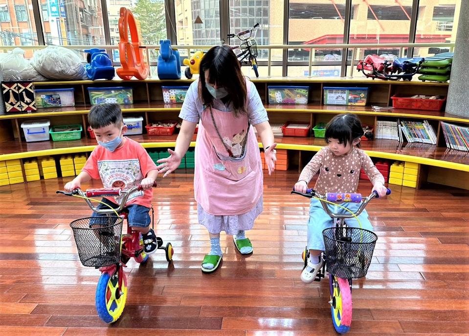 教師指導幼兒練習騎腳踏車