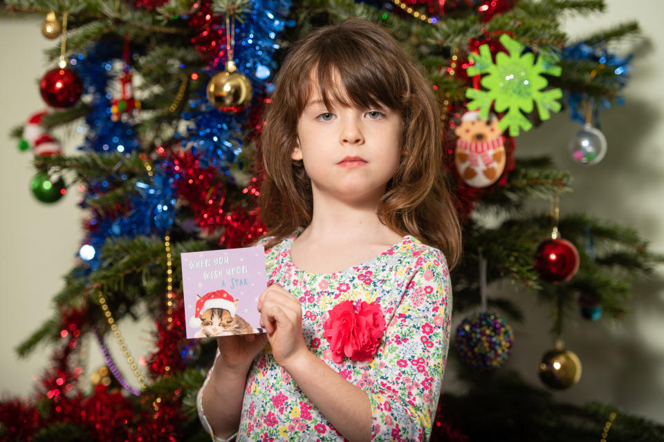 Florence Widdicombe, 6, at her home in Tooting, south London, holding a Tesco Christmas card from the same pack as a card she found contained a message from a Chinese prisoner. The family who found a message from a Chinese prisoner in a Christmas card said they thought it was a "prank" when they first read it.