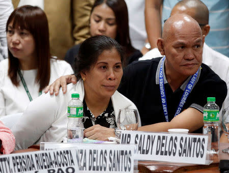 Lorenza and Sandy Delos Santos listen during a Senate hearing on the killing of 17-year-old high school student Kian Delos Santos in a recent police raid, at the Senate headquarters in Pasay city, metro Manila, Philippines August 24, 2017. REUTERS/Dondi Tawatao