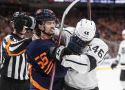Los Angeles Kings' Blake Lizotte (46) and Edmonton Oilers' Kailer Yamamoto (56) rough it up during the third period of Game 1 of an NHL hockey Stanley Cup first-round playoff series, Monday, May 2, 2022 in Edmonton, Alberta. (Jason Franson/The Canadian Press via AP)