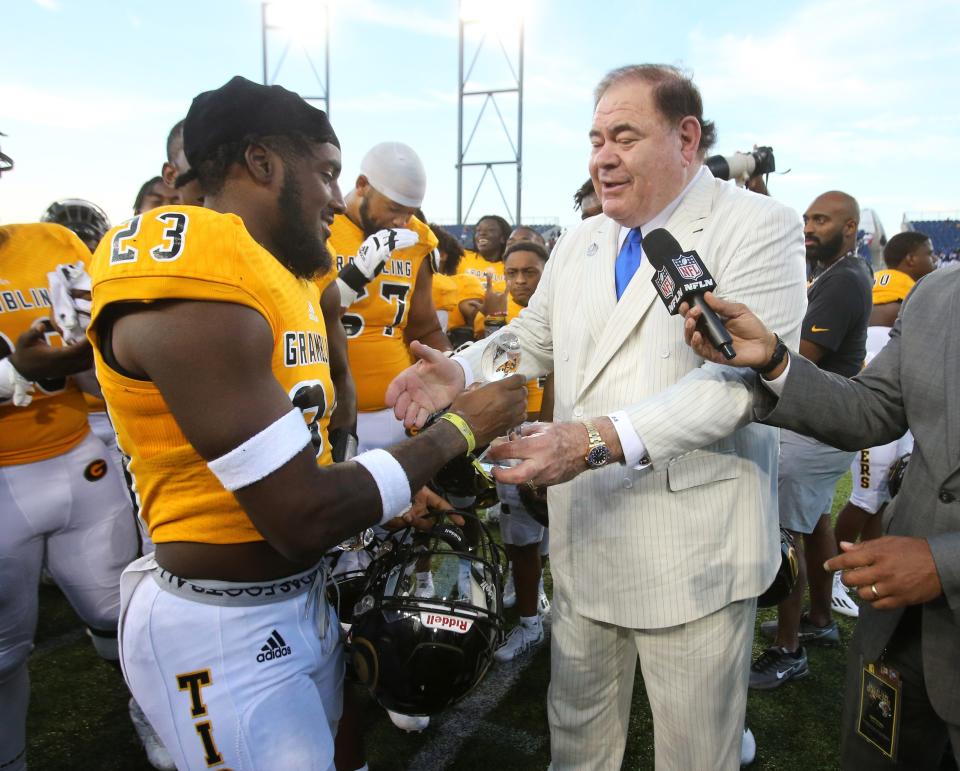 David Baker, right, president and CEO of the Pro Football Hall of Fame presents Co-MVP trophy to Kenan Fontenot, 23, of Grambling State after the Black College Football Hall of Fame Classic against Tennessee State at Tom Benson Hall of Fame Stadium in Canton on Sunday, Sept. 5, 2021. 