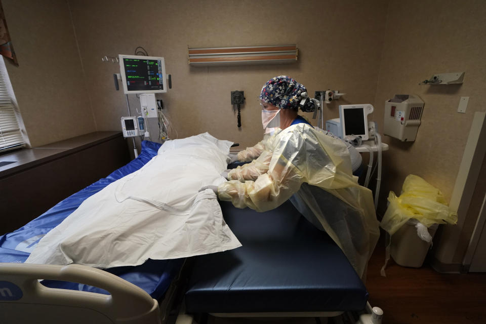 Medical staff move COVID-19 patient who died onto a gurney to hand off to a funeral home van, at the Willis-Knighton Medical Center in Shreveport, La., Wednesday, Aug. 18, 2021. The hospital in northwestern Louisiana thought the COVID-19 pandemic was letting up. Then came the ongoing surge caused by the delta variant. (AP Photo/Gerald Herbert)