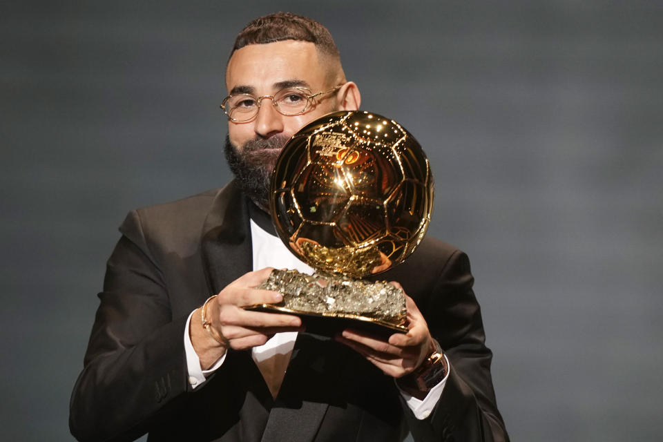 Real Madrid's Karim Benzema celebrates after winning the 2022 Ballon d'Or trophy during the 66th Ballon d'Or ceremony at Theatre du Chatelet in Paris, France, Monday, Oct. 17, 2022. (AP Photo/Francois Mori)