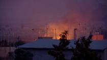 General view of fire burning and smoke billowing out in distance in border town Tel Abyad in Syria seen from Akcakale