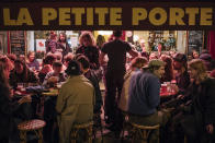 People enjoy a drink on a bar terrace in Paris, Monday, Oct. 5, 2020. French authorities have placed the Paris region on maximum virus alert on Monday, banning festive gatherings and requiring all bars to close but allowing restaurants to remain open, as numbers of infections are rapidly increasing. (AP Photo/Lewis Joly)