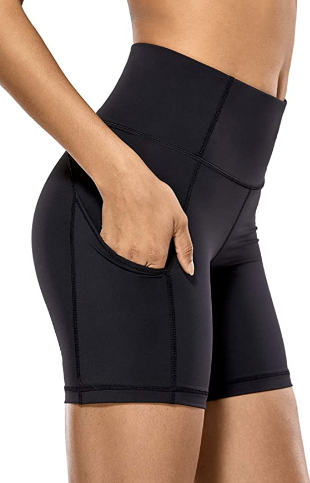 Cropped photo shows lower torso of woman in black CRZ YOGA Women&#39;s workout shorts, just $28 from Amazon