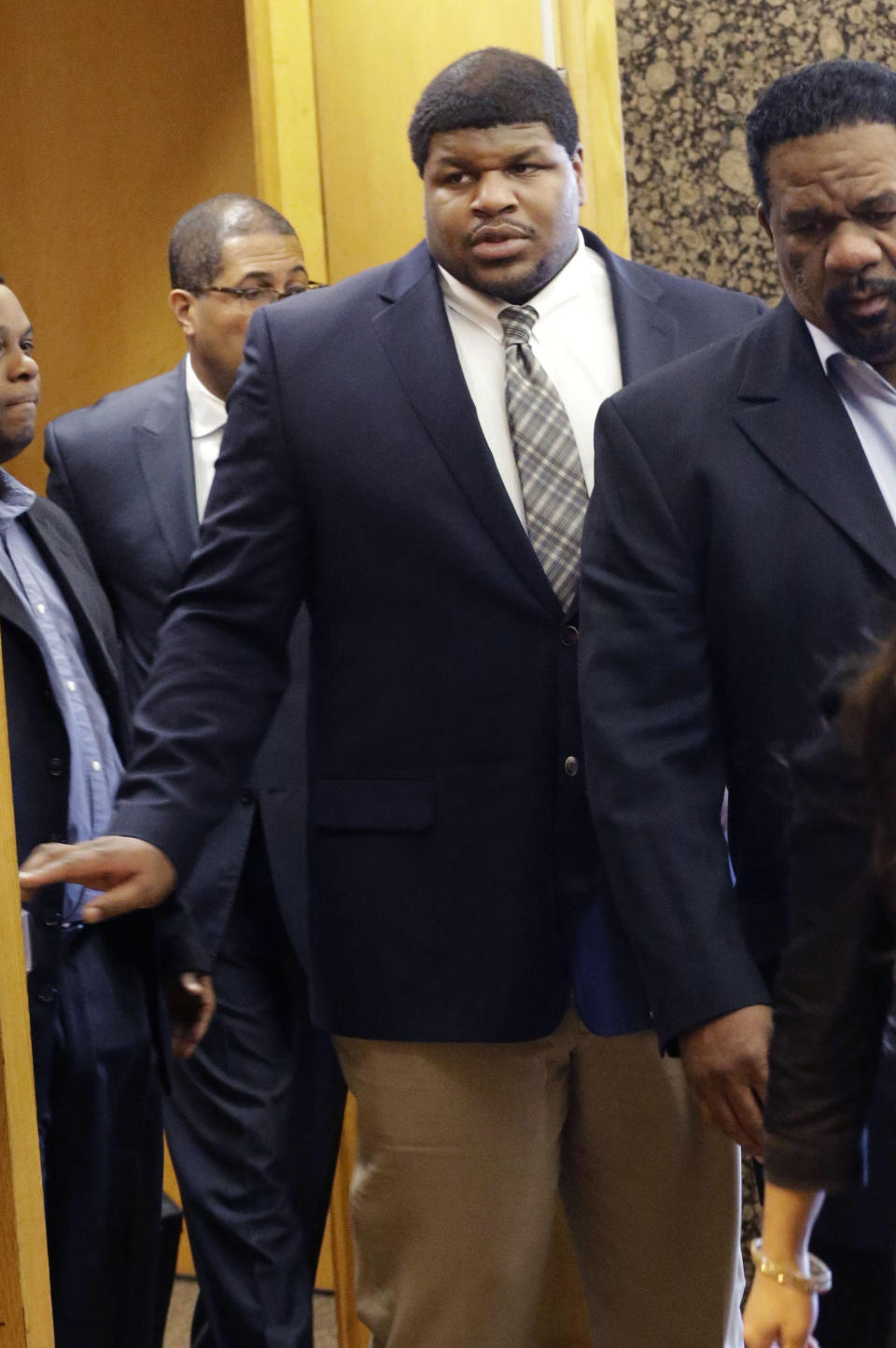 Former Dallas Cowboy Josh Brent walks out of court with his legal team at the end of the day of testimony in his trial for intoxication manslaughter, Wednesday, Jan. 15, 2014, in Dallas. Brent is accused of driving drunk at the time of a December 2012 crash that killed Cowboys practice squad player Jerry Brown. (AP Photo/LM Otero)