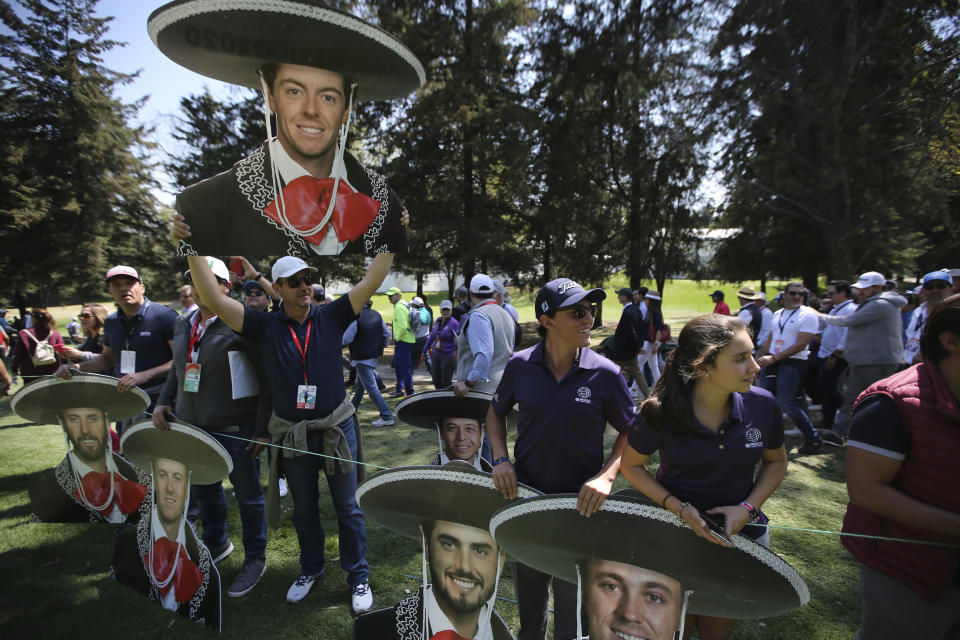 A fan holds up a cutout depicting golfer Rory McIlroy of Northern Ireland dressed as a mariachi, during the second round for the WGC-Mexico Championship golf tournament, at the Chapultepec Golf Club in Mexico City, Mexico City, Friday, Feb. 21, 2020.(AP Photo/Fernando Llano)