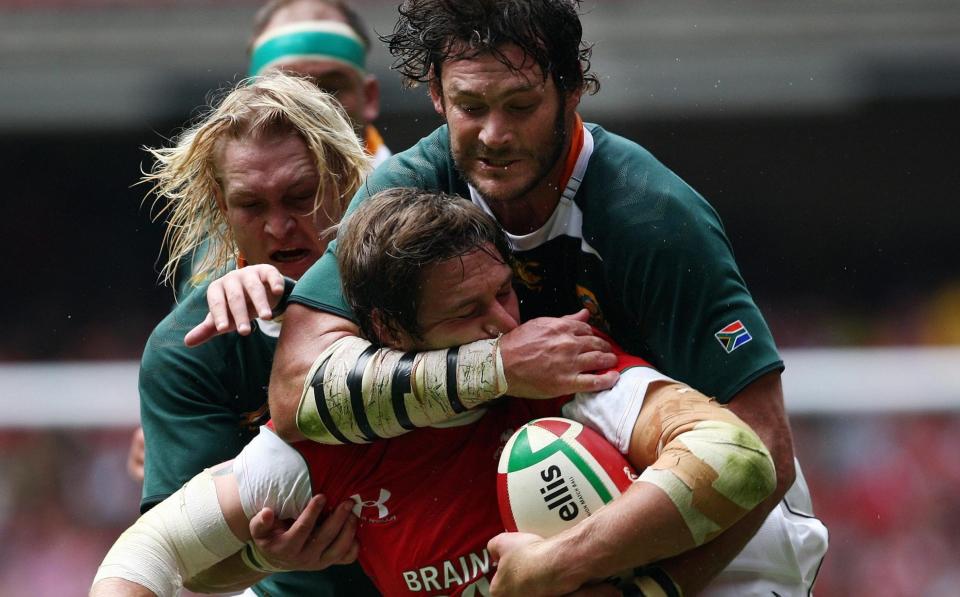 Wales Ryan Jones is tackled by South Africa's Danie Roussouw during the International Friendly at the Millennium Stadium - PA