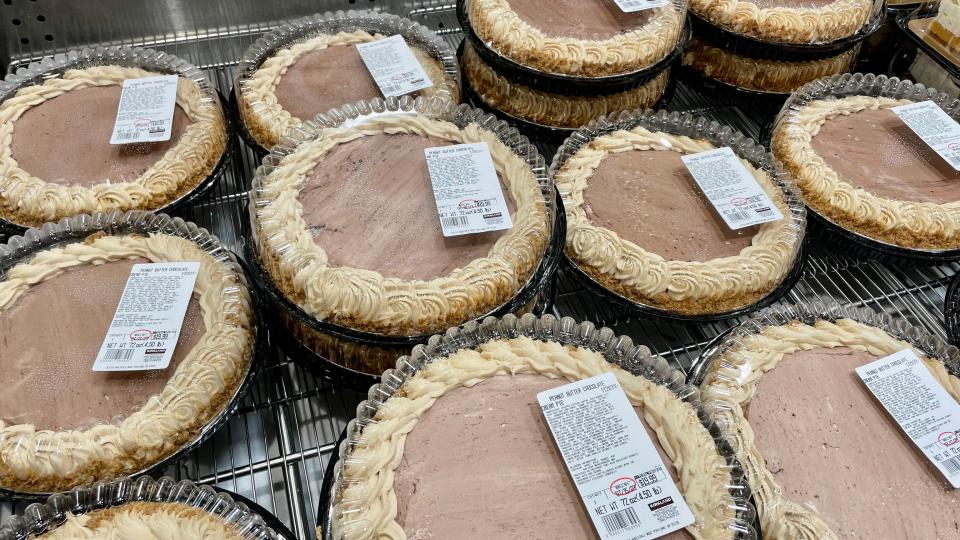 Chocolate peanut butter pies at costco in plastic cases on a display rack 