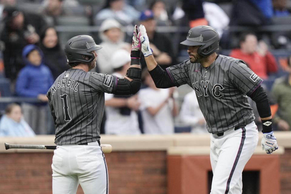 New York Mets' J.D. Martinez, right, celebrates with Jeff McNeil after hitting a home run during the ninth inning of a baseball game, Saturday, May 11, 2024, in New York. The Braves won 4-1. (AP Photo/Frank Franklin II)