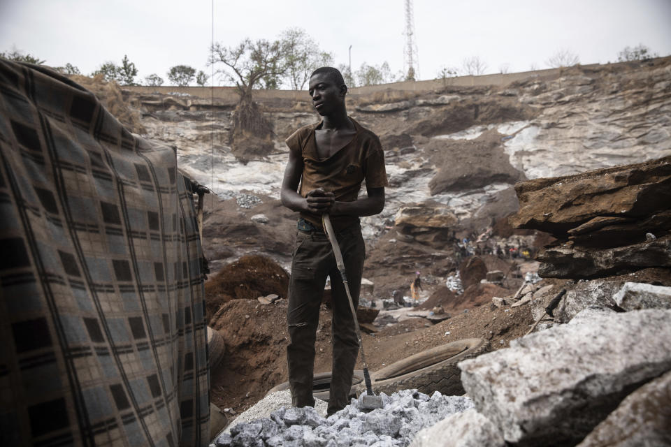 Men work in a Pissy granite mine in Ouagadougou, Burkina Faso, Monday April 25, 2022. he influx of people displaced by the country's rapidly rising Islamic violence is causing competition among the approximately 3,000 people working at the granite mine. At least 500 displaced people started working at the mine last year making it harder for the original miners to earn a living, said Abiba Tiemtore, head of the site. (AP Photo/Sophie Garcia)