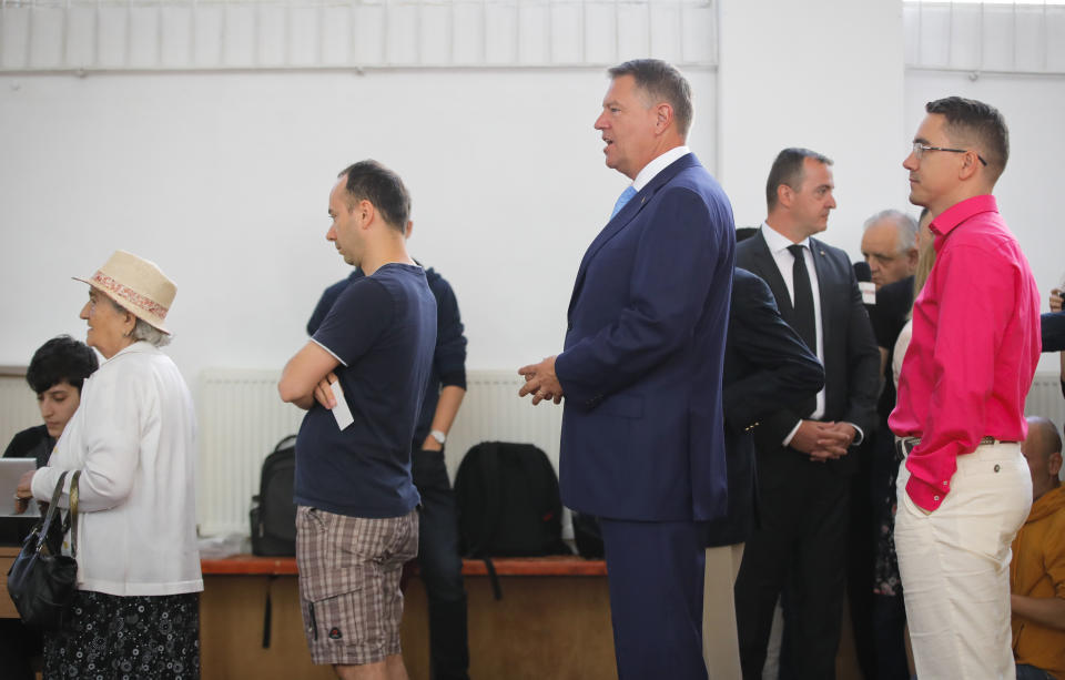 Romanian President Klaus Iohannis waits to cast his ballot in Bucharest, Romania, Sunday, May 26, 2019. Romanians vote in the European Parliament elections and a referendum called by Iohannis on judicial system laws.(AP Photo/Vadim Ghirda)