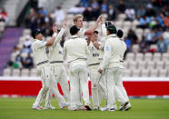 New Zealand's Kyle Jamieson celebrates with teammates the dismissal of India's Rohit Sharma during the second day of the World Test Championship final cricket match between New Zealand and India, at the Rose Bowl in Southampton, England, Saturday, June 19, 2021. (AP Photo/Ian Walton)