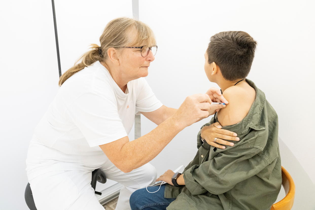 A health worker administers a coronavirus disease (COVID-19) vaccine during the pop-up vaccination day observed inside a supermarket in Ishoej, Denmark, September 11, 2021. Claus Bech/ Ritzau Scanpix via REUTERS        ATTENTION EDITORS - THIS IMAGE WAS PROVIDED BY A THIRD PARTY. DENMARK OUT. NO COMMERCIAL OR EDITORIAL SALES IN DENMARK.