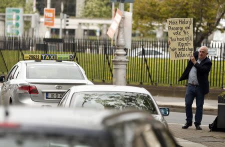 A Yes campaigner holds up a placard in central Dublin in Ireland May 21, 2015. REUTERS/Cathal McNaughton