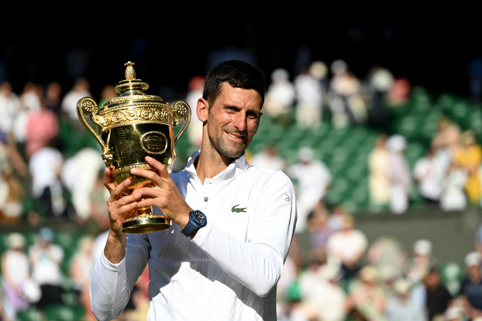 LONDON, ENGLAND - JULY 10: Gentlemen's Singles Final Novak Djokovic (SRB) v Nick Kyrgios (AUS) - Novak Djokovic celebrates victory by holding the trophy during day fourteen of The Championships Wimbledon 2022 at All England Lawn Tennis and Croquet Club on July 10, 2022 in London, England. (Photo by Stringer/Anadolu Agency via Getty Images)