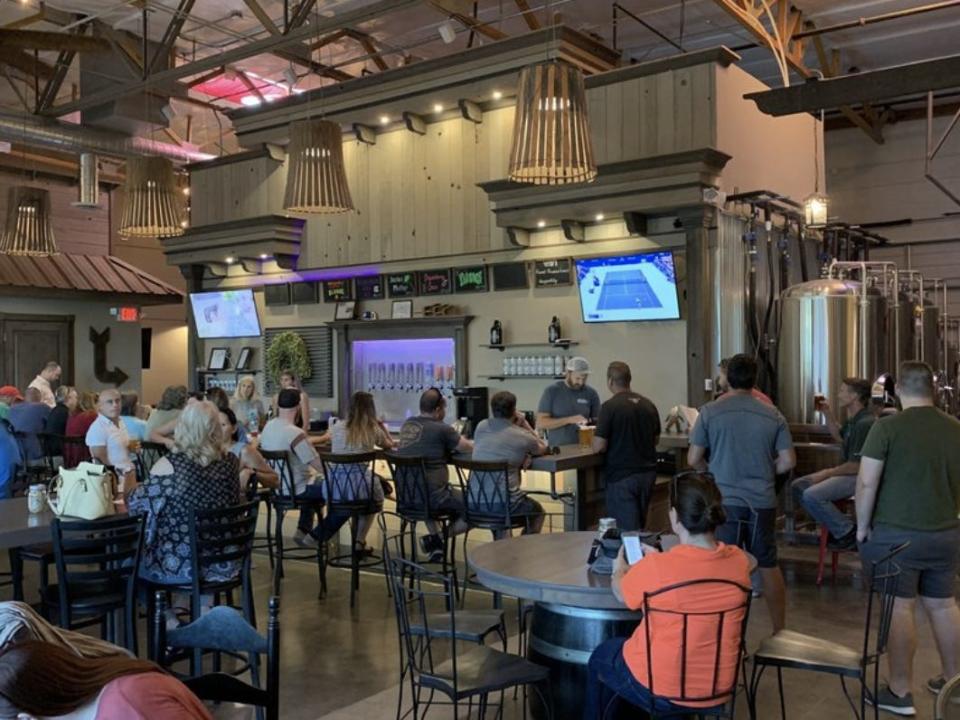 Patrons sitting at the bar in Front Pourch Brewing