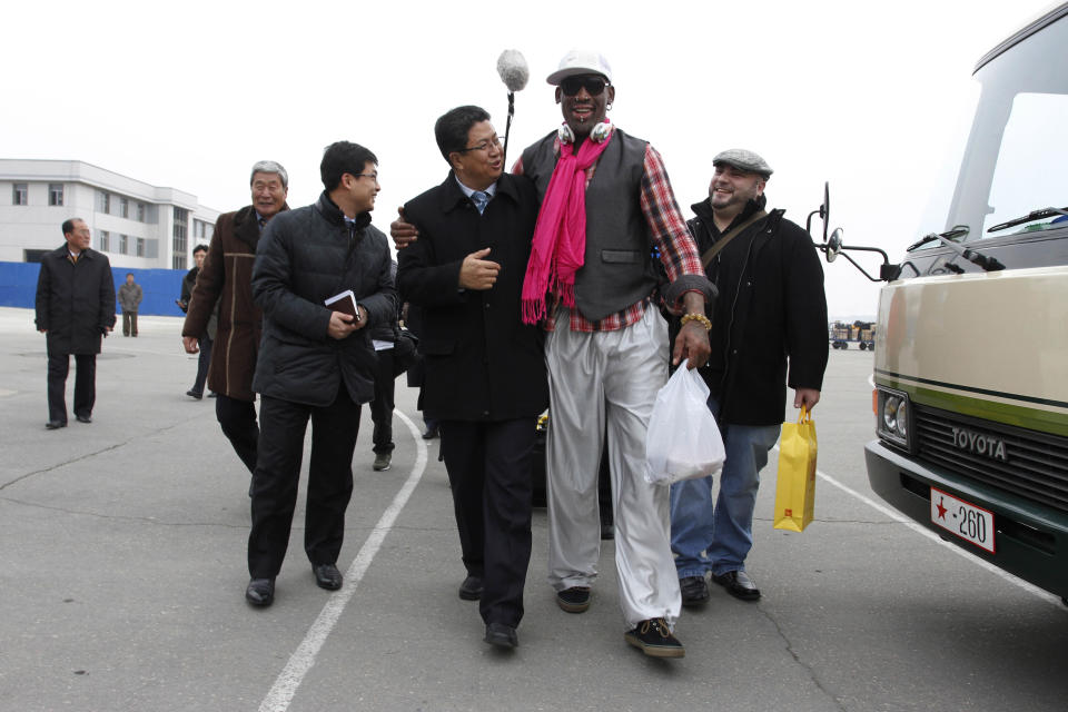 Former NBA basketball star Dennis Rodman, second right, walks with North Korea's Sports Ministry Vice Minister Son Kwang Ho, third right, upon his arrival at the international airport in Pyongyang, North Korea, Monday, Jan. 6, 2014. Rodman took a team of former NBA players on a trip for an exhibition game on Kim Jong Un's birthday, Wednesday, Jan. 8. (AP Photo/Kim Kwang Hyon, File)