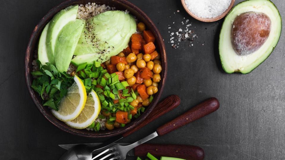 healthy chickpea avocado quinoa bowl on gray background viewed from above, favorite vegan meal
