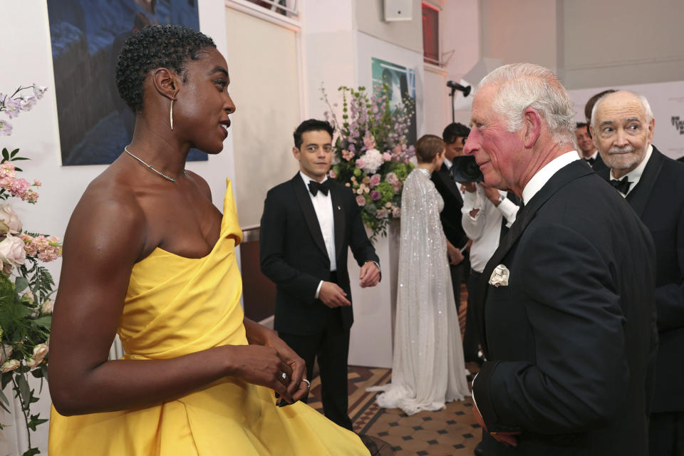 Britain's Prince Charles, right, speaks with British actress Lashana Lynch upon arrival for the World premiere of the new film from the James Bond franchise 'No Time To Die', in London, Tuesday, Sept. 28, 2021. (Chris Jackson/Pool Photo via AP)