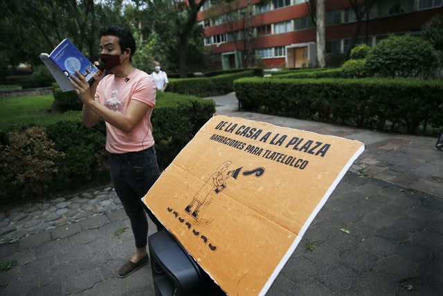 Percibald Garcia uses a microphone to read aloud children’s stories amid the high-rise housing complex of Tlatelolco in Mexico City 