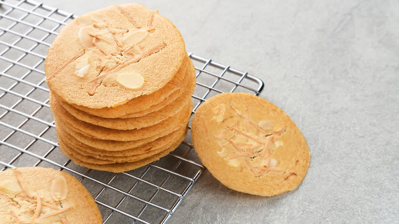 Thin and crispy almond cookies on cooling rack 