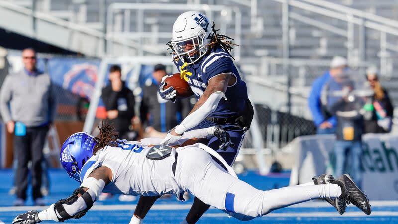 Utah State running back Rahsul Faiso cuts back with the ball to avoid the tackle attempt by Georgia State linebacker Kevin Swint in  the Famous Idaho Potato Bowl, Saturday, Dec. 23, 2023, in Boise, Idaho. Faison has the goal of becoming one of the best players in the country this fall.