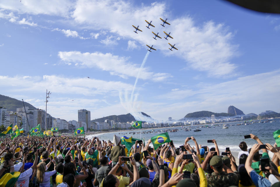 An aerial acrobatic team flies over Copacabana beach during a military display and rally called by President Jair Bolsonaro to celebrate the bicentennial of the country's independence from Portugal ,in Rio de Janeiro, Brazil, Wednesday, Sept. 7, 2022. (AP Photo/Silvia Izquierdo)