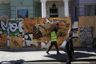 <p>Boarding is erected in front of residential properties ahead of the annual Notting Hill Carnival, on Aug. 26, 2016 in London, England. Many shops, businesses and residential properties are boarded up to prevent damage to their properties. More than one million people are expected to enjoy this year’s Notting Hill Carnival. (Photo: Dan Kitwood/Getty Images) </p>